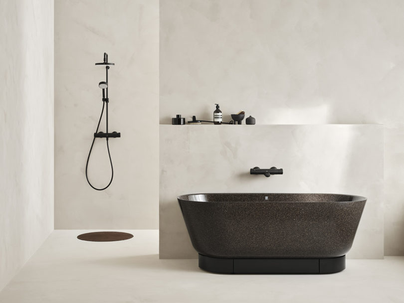 Woodio freestanding bathtub in Char (black) finish with shower to the left.