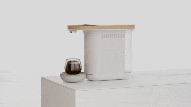 Animation of Woolly coffee machine pouring into small glass cup.