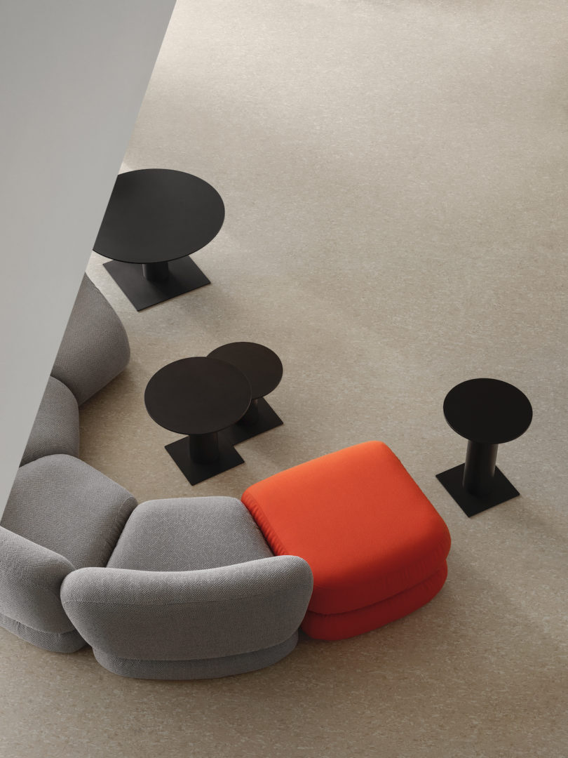 grey and red modular seating with black metal tables