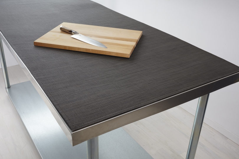 knife and cutting board on top of black Worktop covering