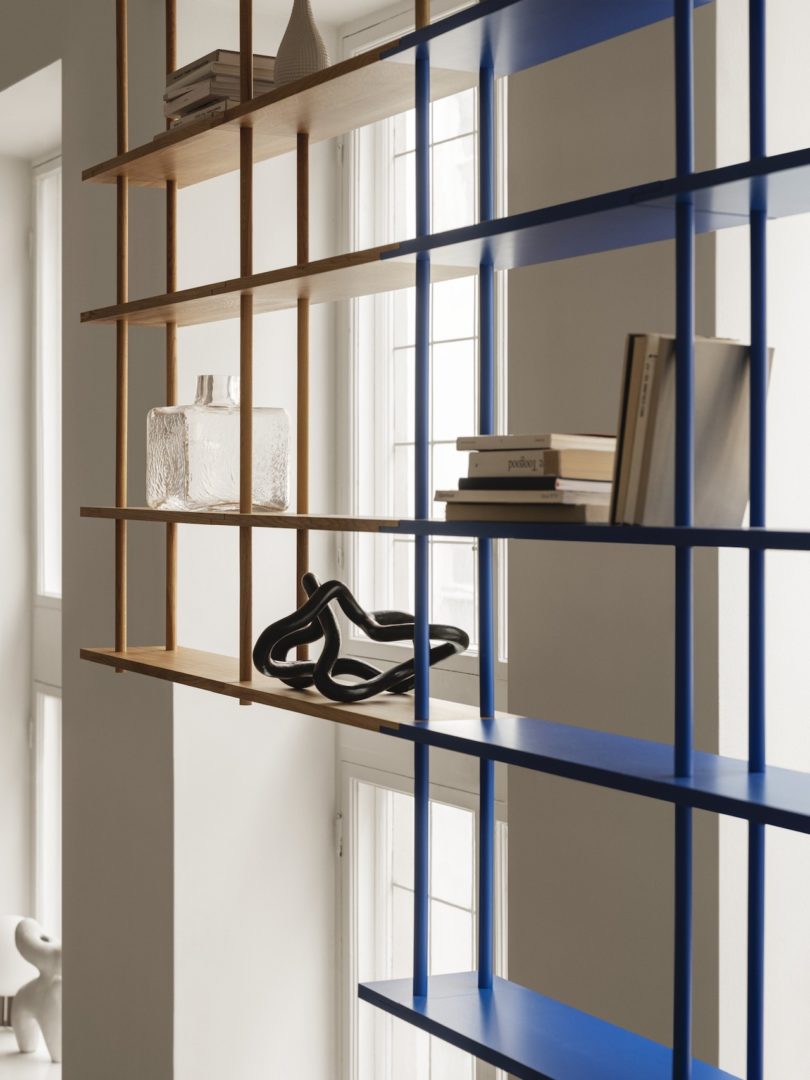 blue and yellow modular shelving hung from ceiling