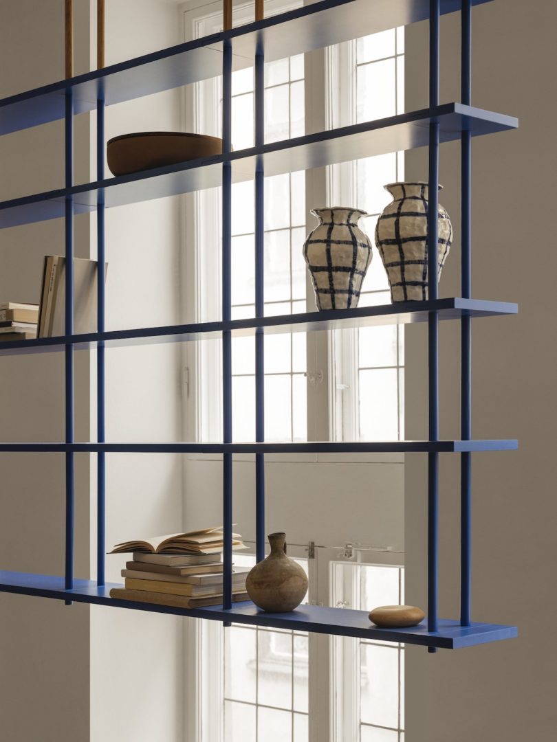 blue modular shelving hung from ceiling