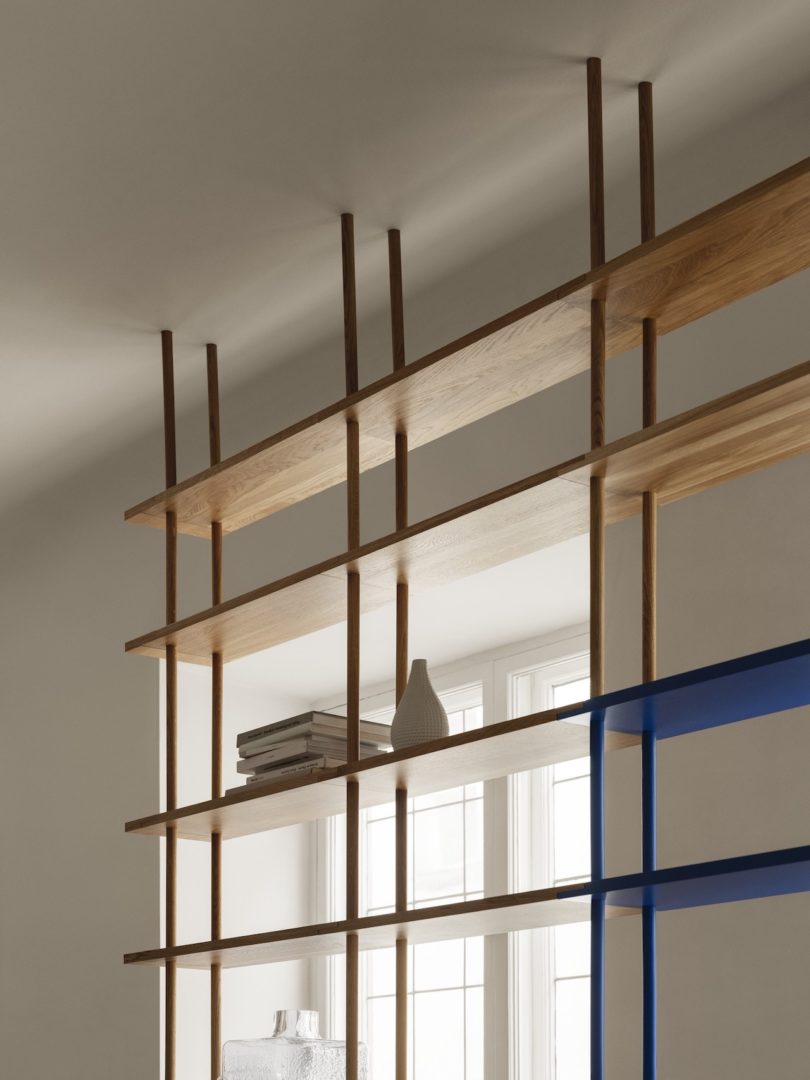 blue and yellow modular shelving hung from ceiling