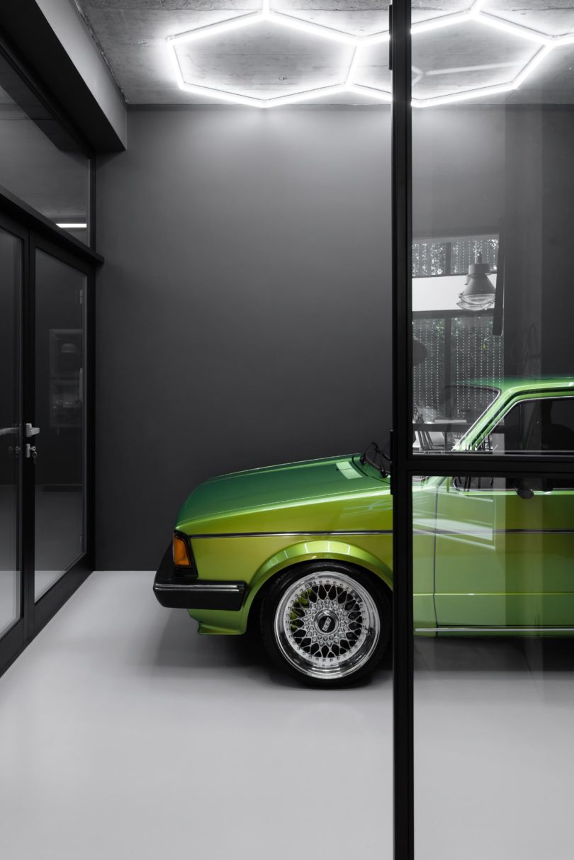 modern interior car garage with partial view of green car