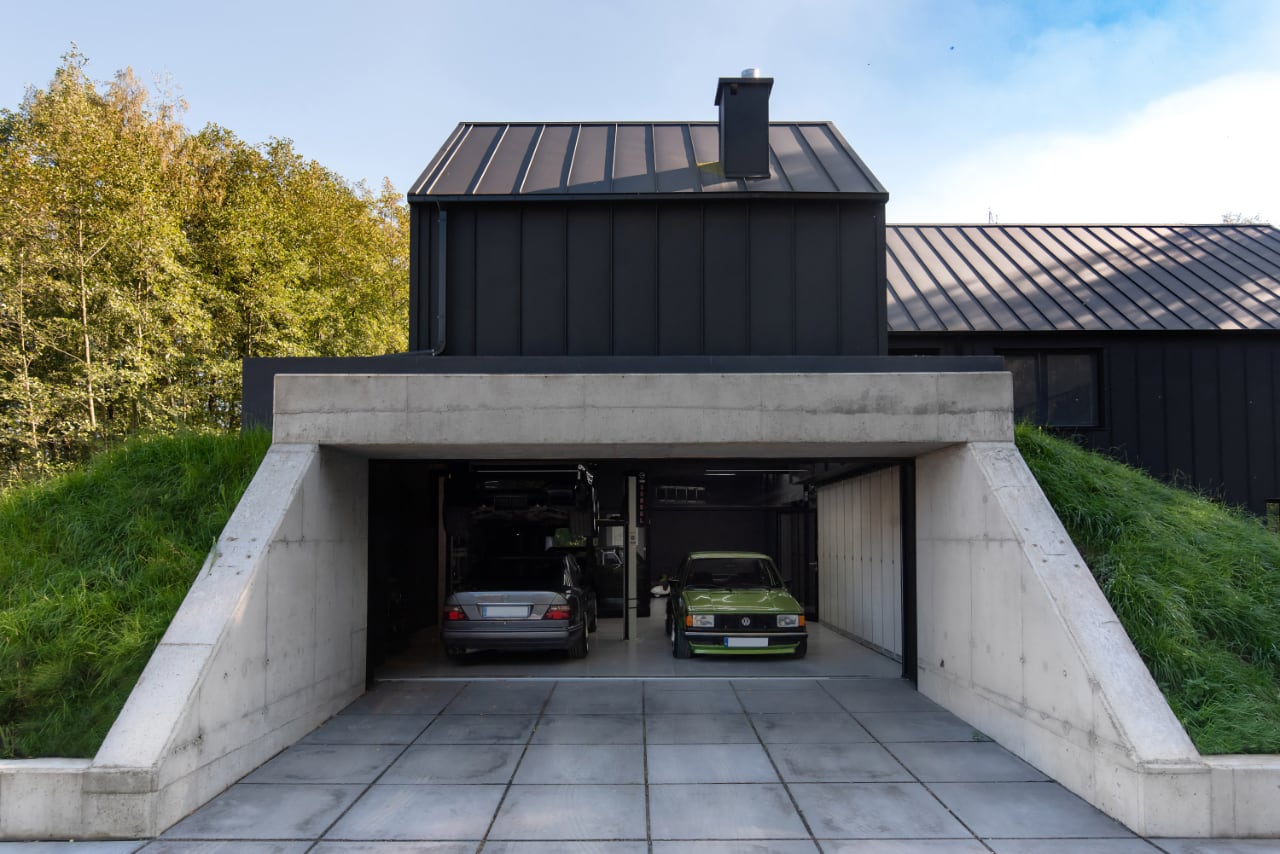 Hilltop House Cleverly Hides a Garage Underneath Grassy Slopes