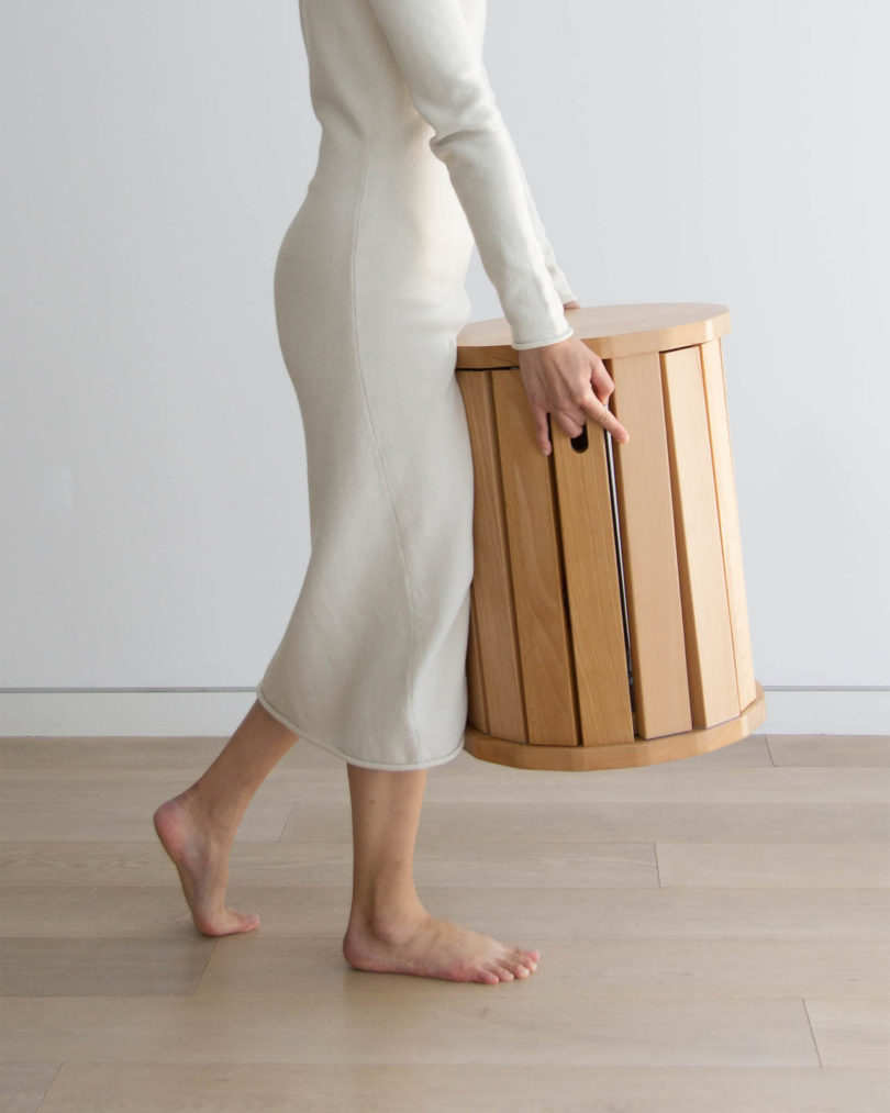 person carrying wooden side table