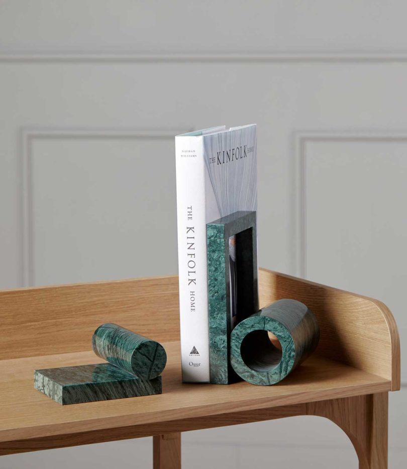 book and bookends on two tiered wood shelf