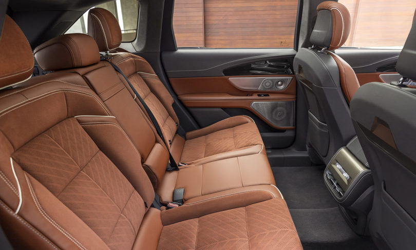Rear leather seats of the 2024 Lincoln Black Label Nautilus Hybrid with Redwood interior finishes.