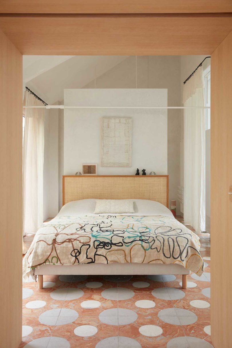 interior view of modern bedroom with patterned bedspread