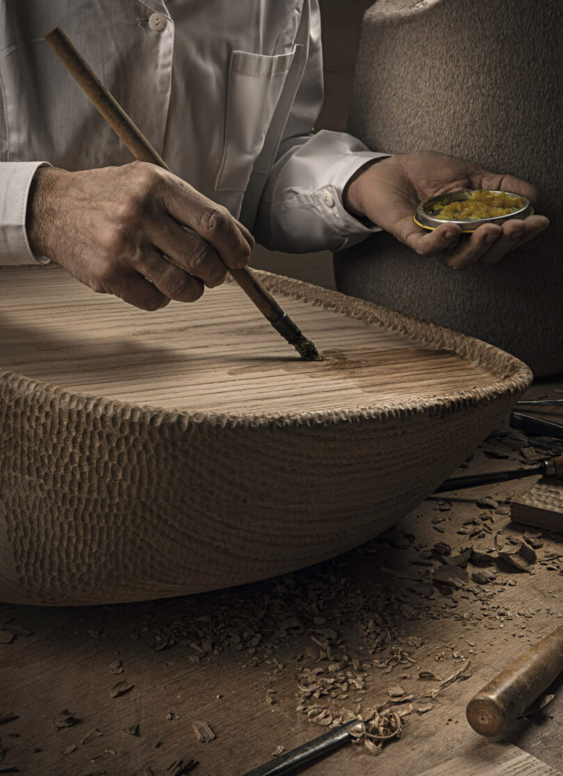 person carving wood