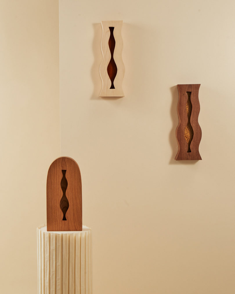 three wood wall sconces displayed
