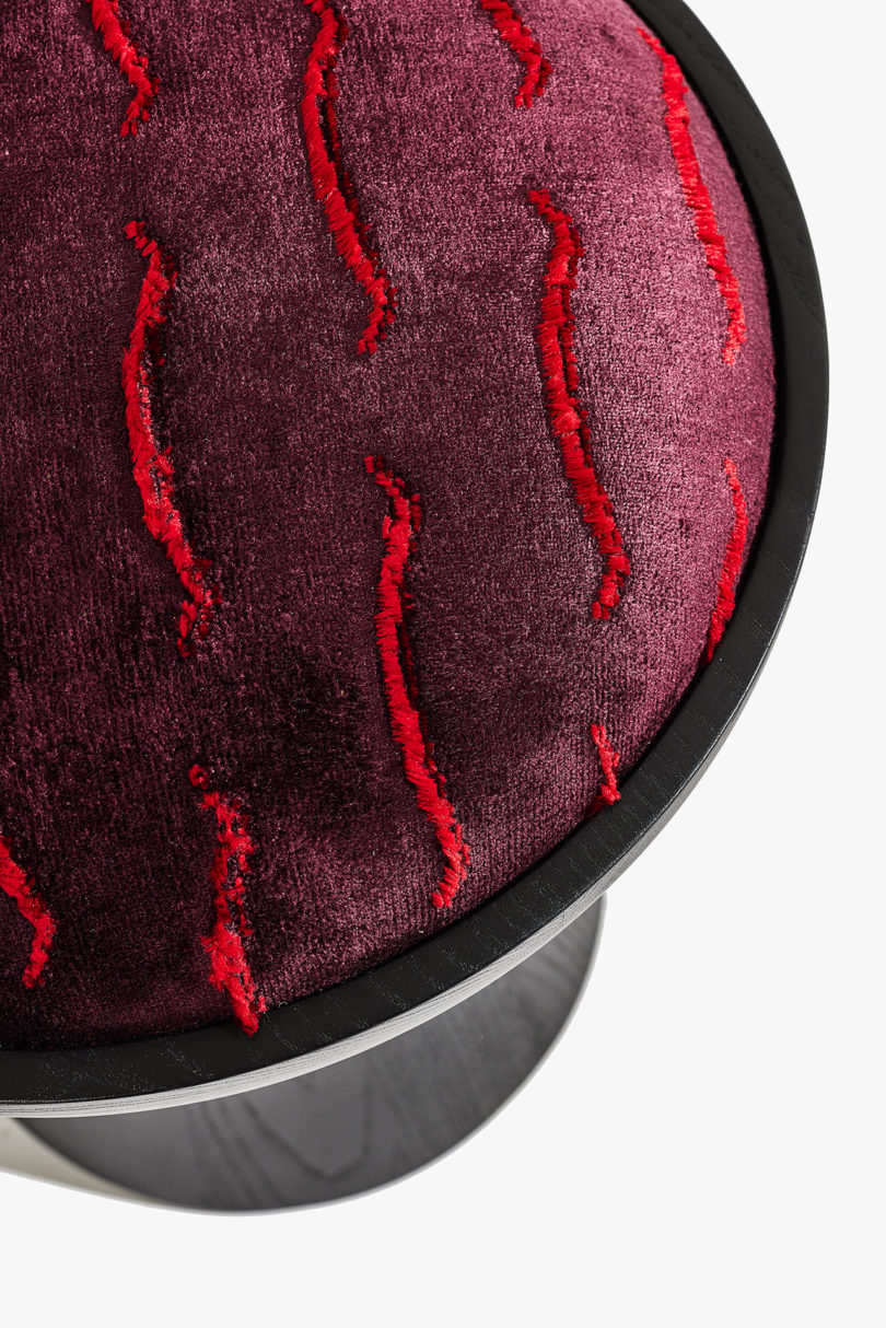 detail of upholstered black and red stool