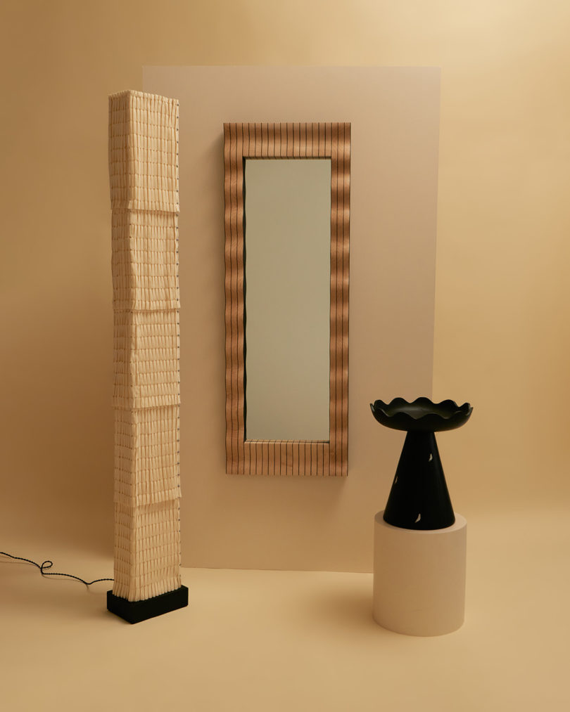 tall floor lamp, wall mirror, and side table