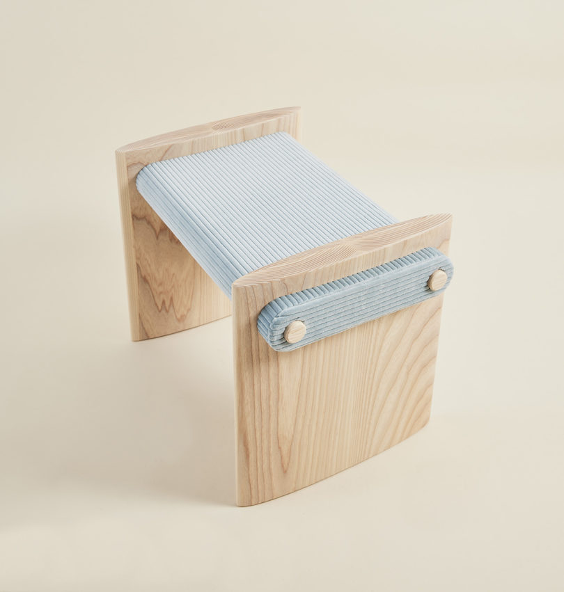 wood and light blue corduroy stool