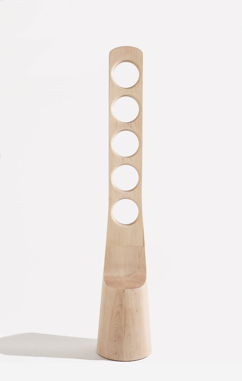 tall, thin wood piece with five large holes