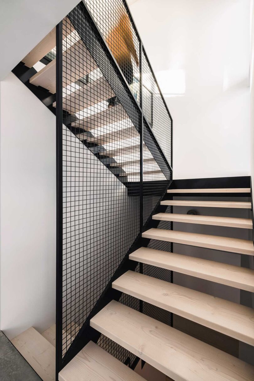 angled view of open wood and black staircase
