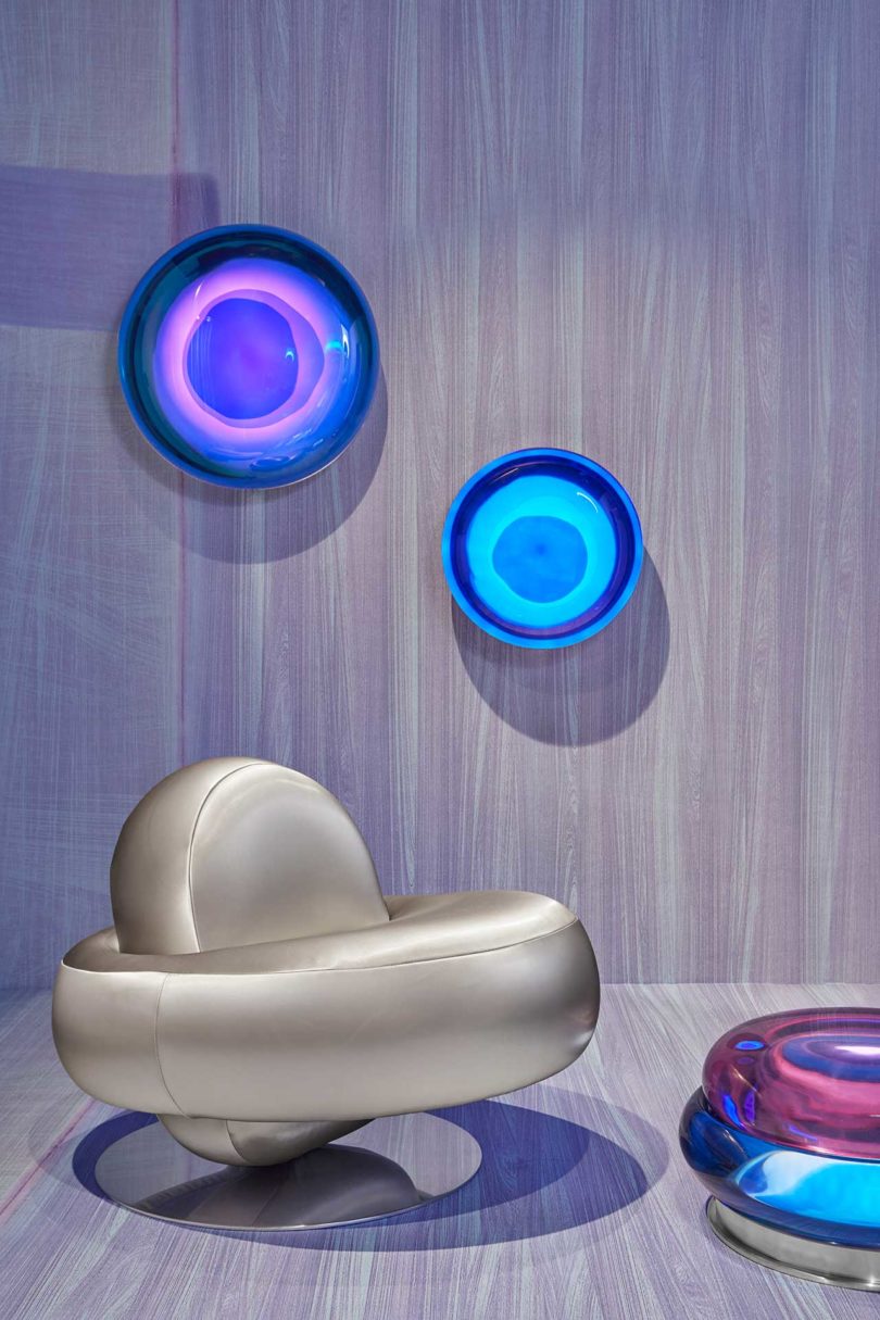 lavender gallery room with space-age silver chair and glowing colorful orbs