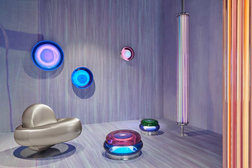 lavender gallery room with space-age silver chair and glowing colorful orbs