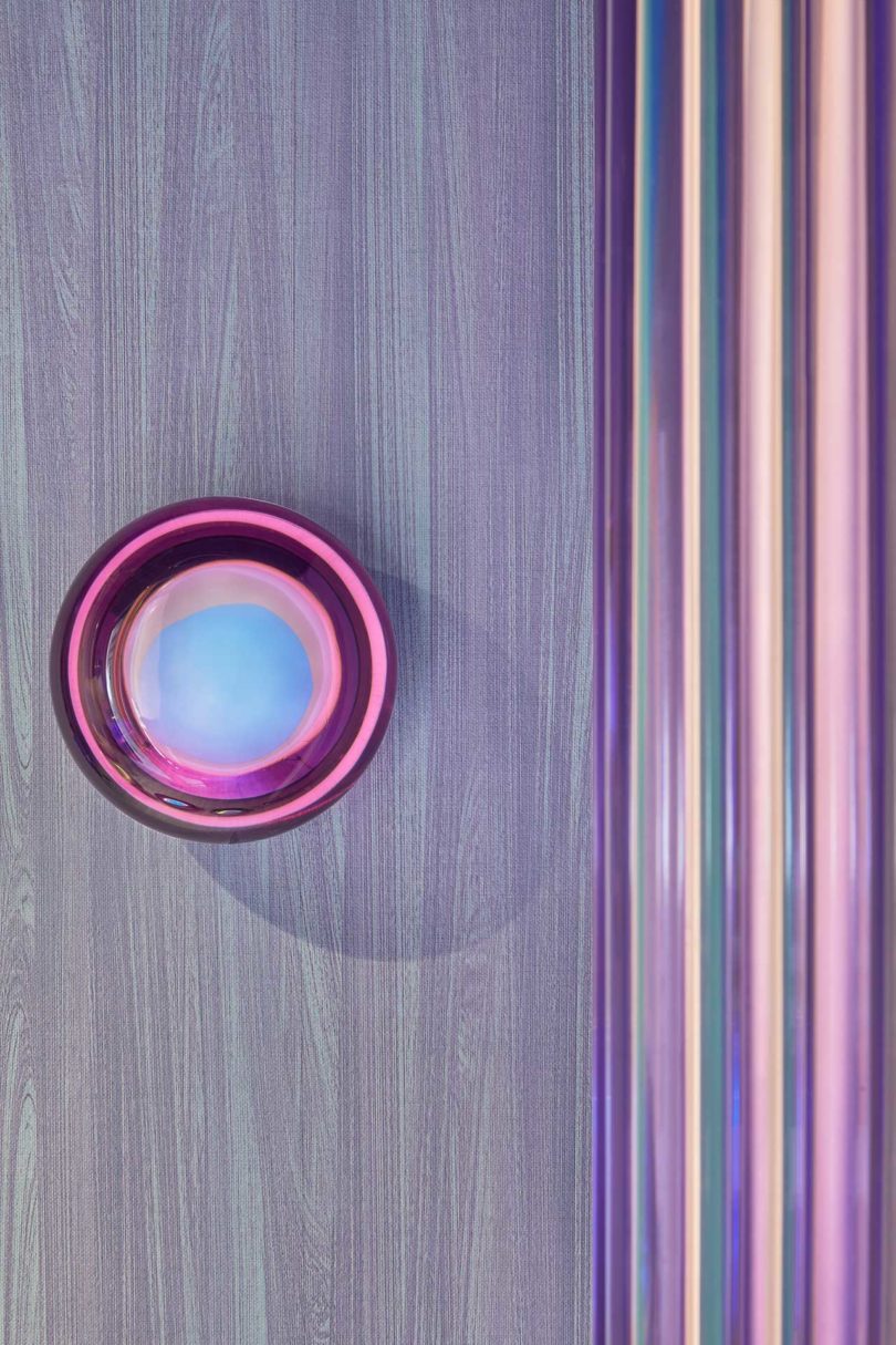 closeup of lavender wall with glowing colorful orb