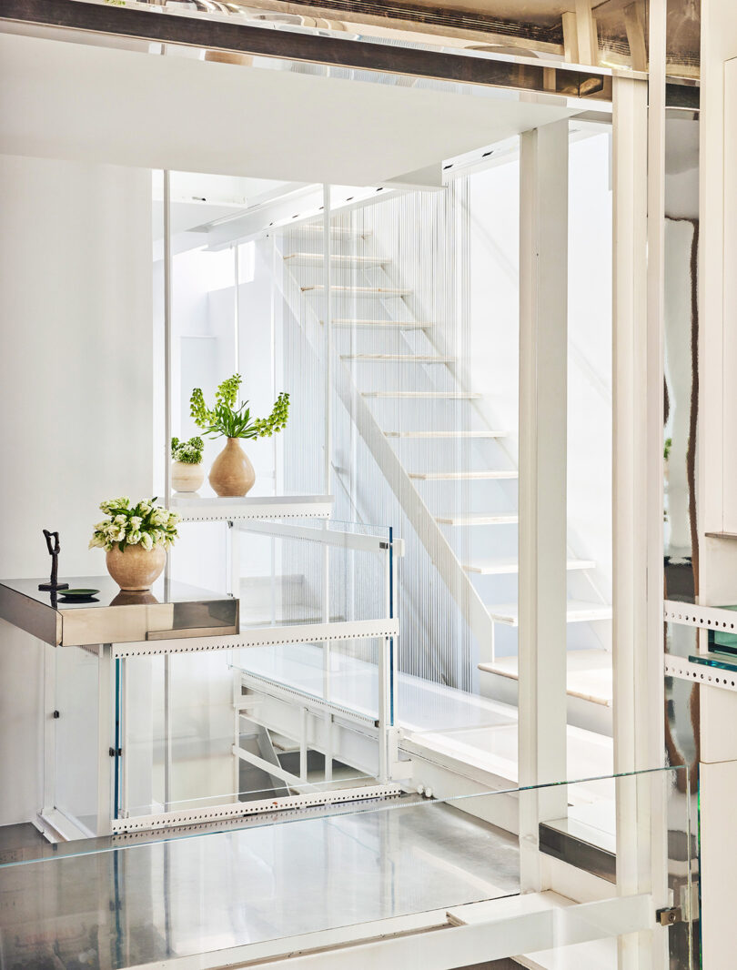 all white styled interior space with staircase