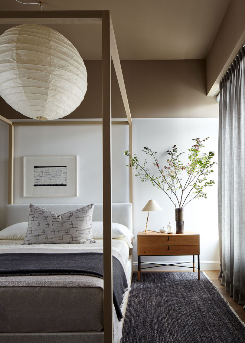 styled bedroom with modern canopy bed and large lantern ceiling light