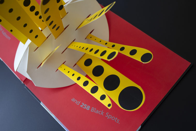 red, yellow, black, and white page from a pop-up book