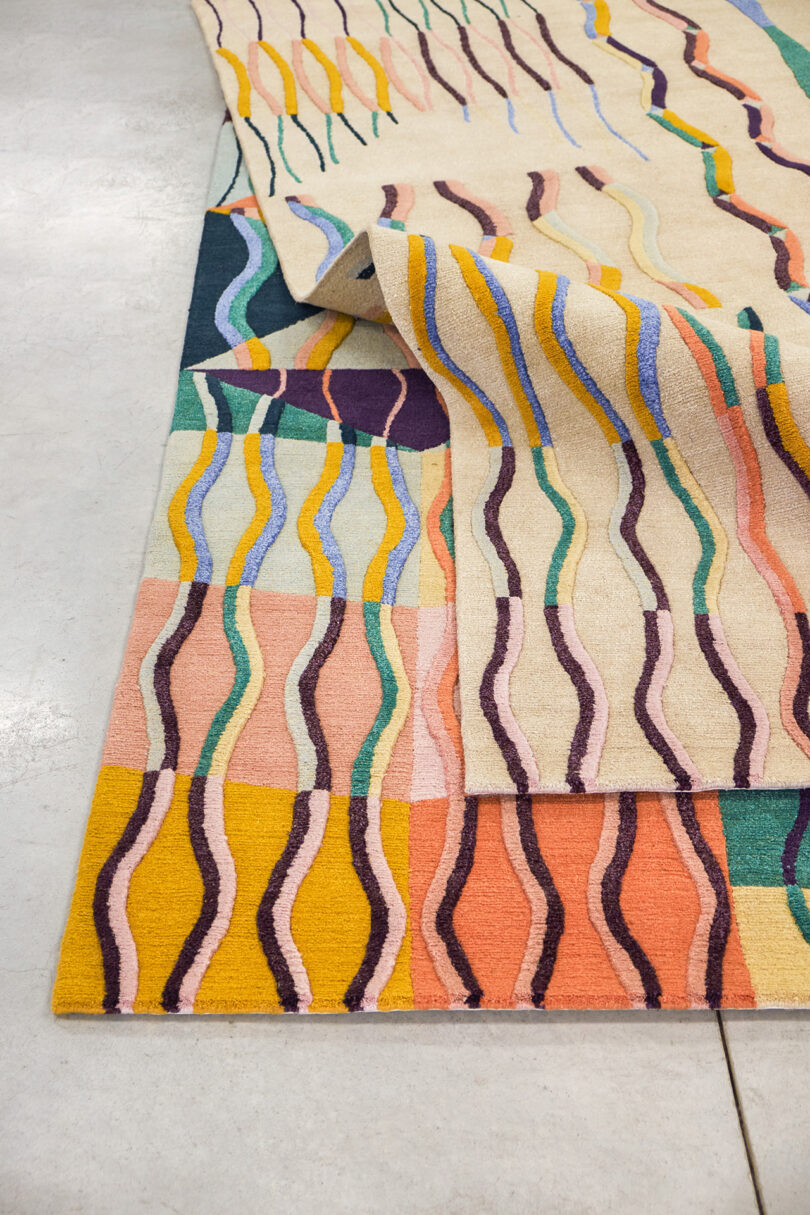 two multicolor abstract rectangular floor rugs