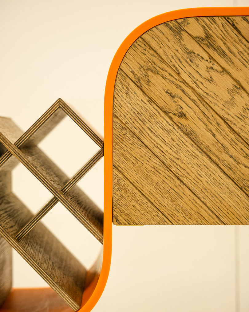detail of bright orange and wood bar cabinet and wine rack