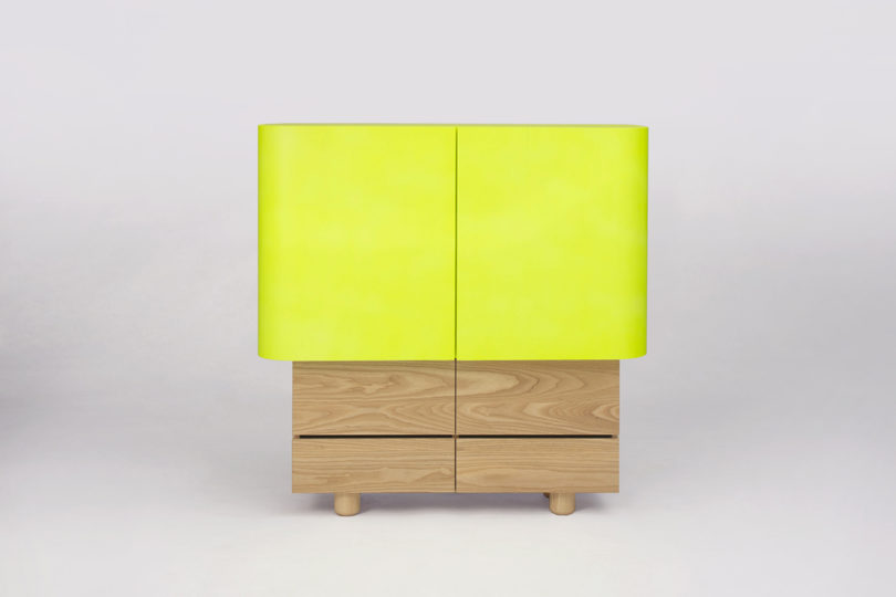 neon yellow and light wood cabinet