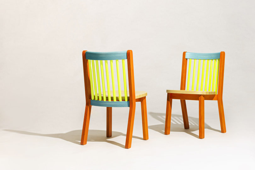 two blue, orange, and neon yellow dining chairs