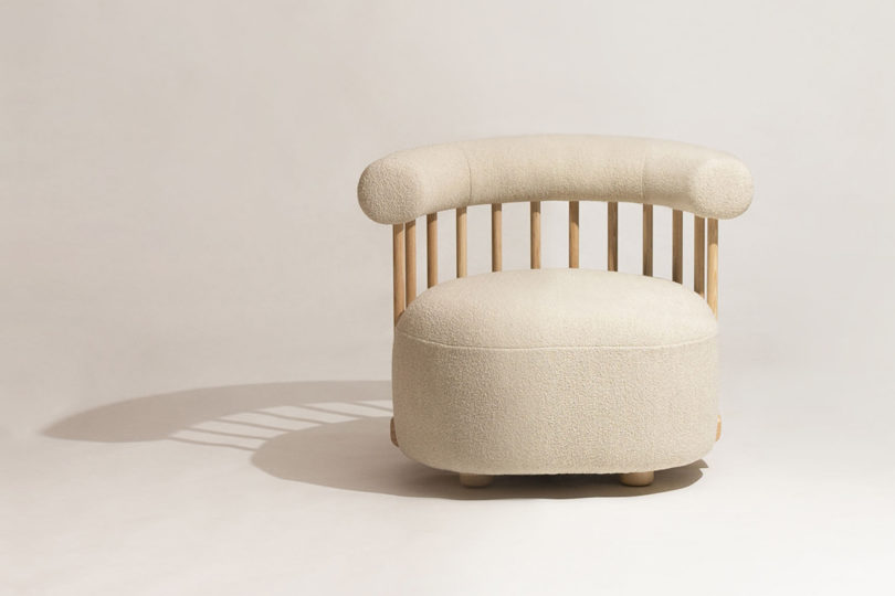 rounded light wood and upholstery armchair