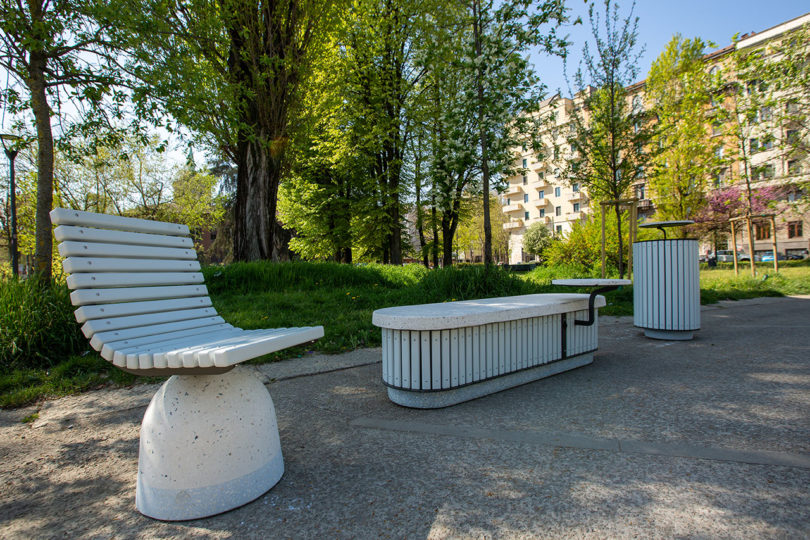 outdoor cement chair, bench, and garbage can