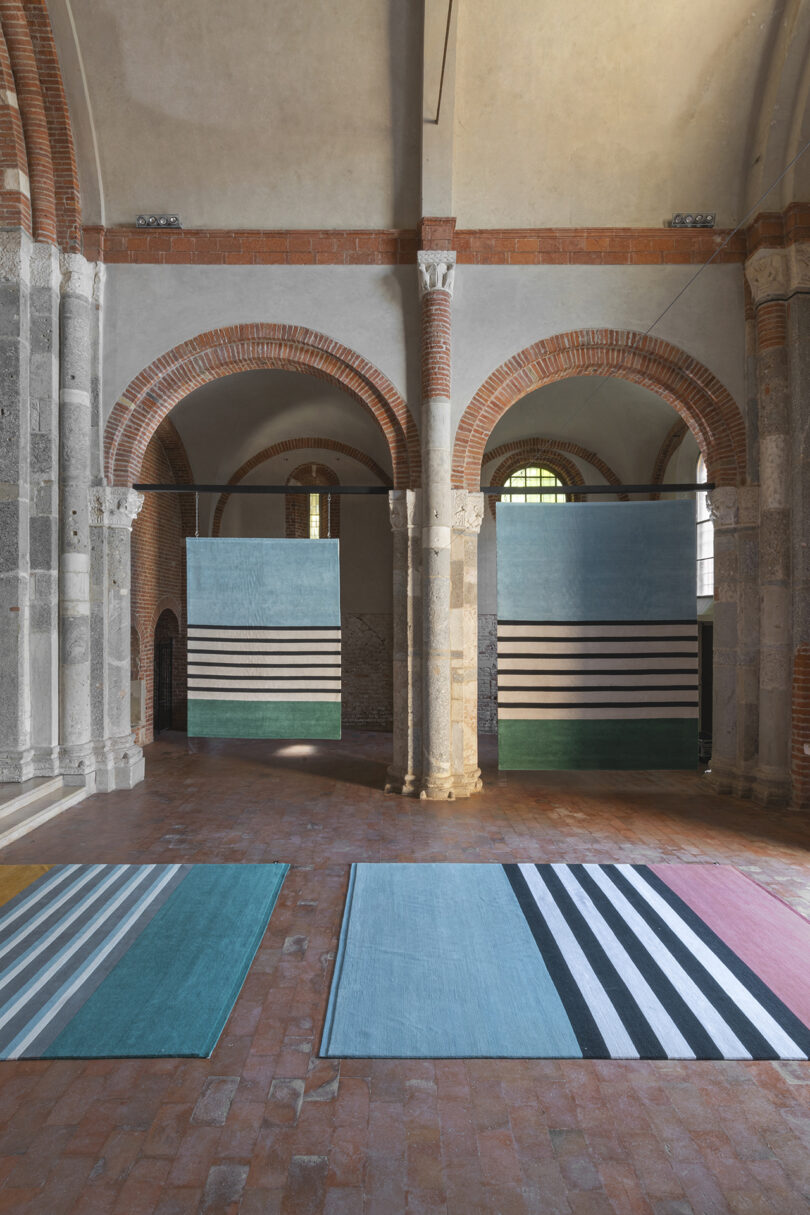 striped floor rugs on display in a church