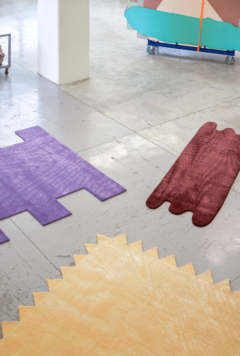 three abstract shaped floor rugs