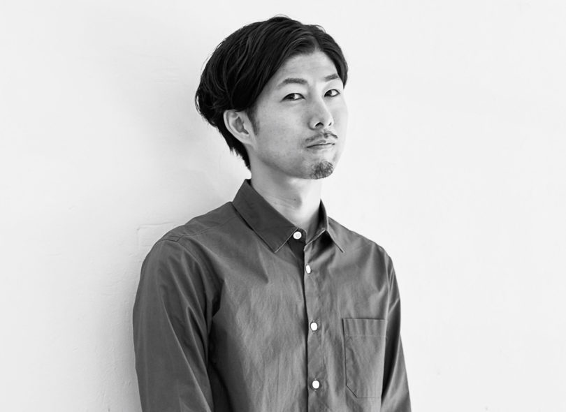 Black and white portrait shot of industrial designer, Nao Iwamatsu wearing button up long sleeved shirt.
