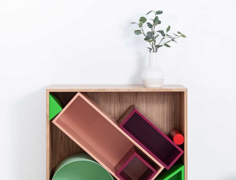 partial view of modular storage shelf with colorful geometric boxes inside
