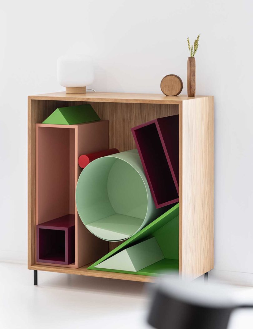 slight angled view of modular storage shelf with colorful geometric boxes inside