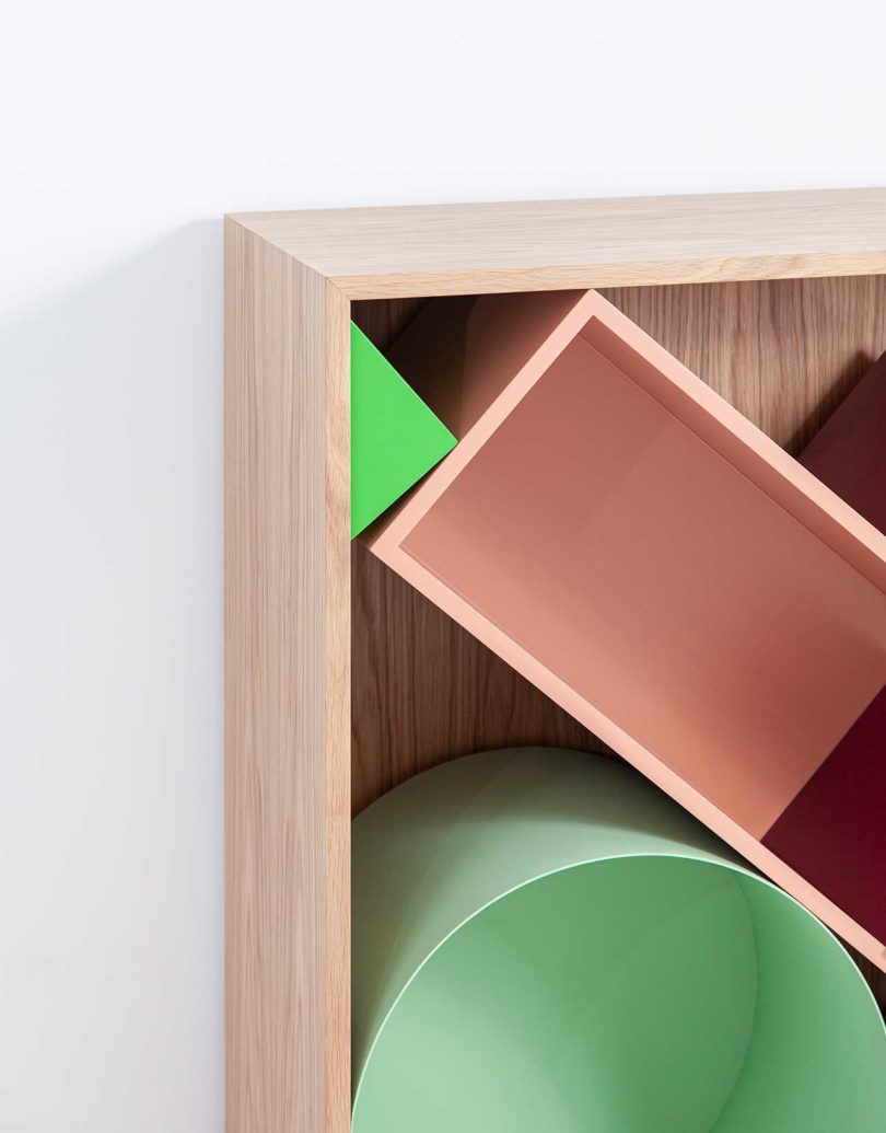 partial corner view of modular storage shelf with colorful geometric boxes inside