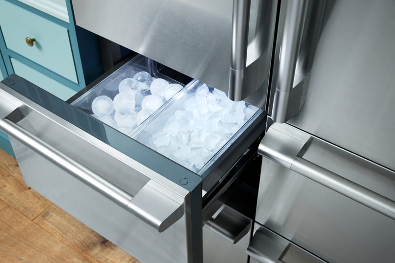 open stainless drawer inside of a french door refrigerator/freezer filled with two types of ice