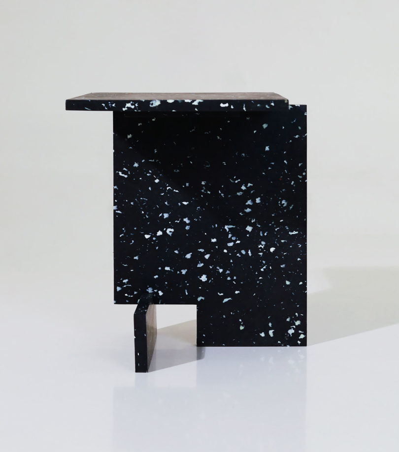 abstract angular white spattered black side table