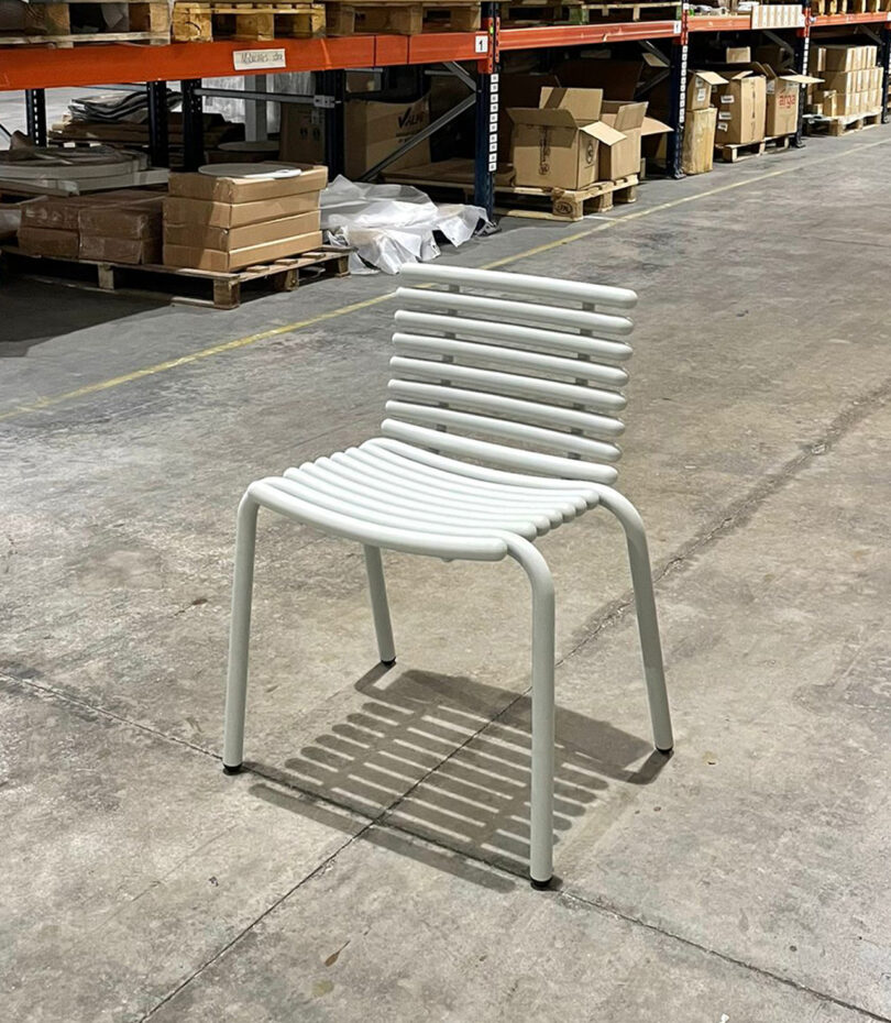 modern white outdoor chair prototype in a warehouse