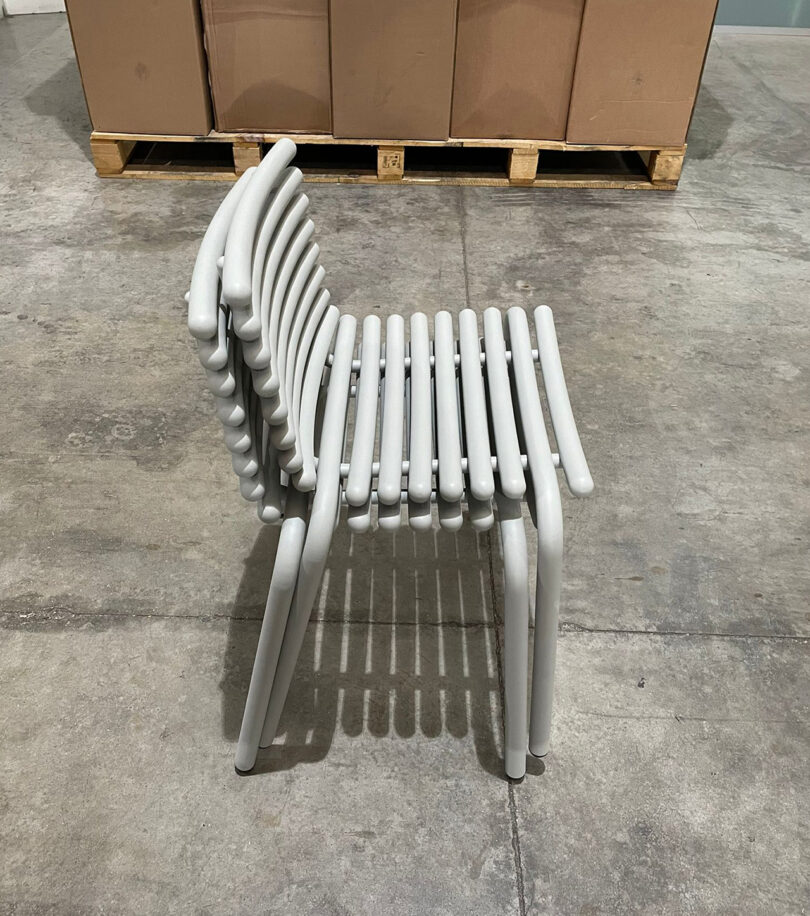modern white outdoor chair prototype in a warehouse