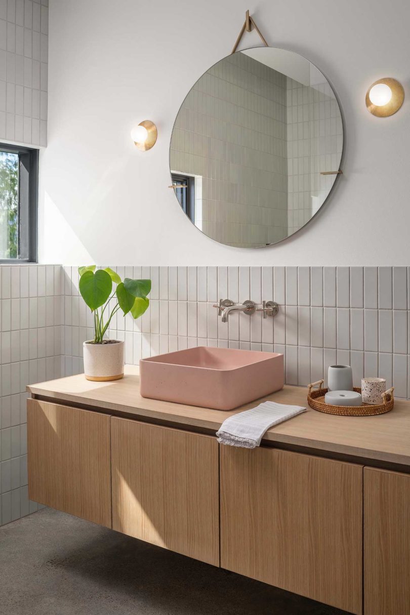 angled view of modern bathroom with pink sink
