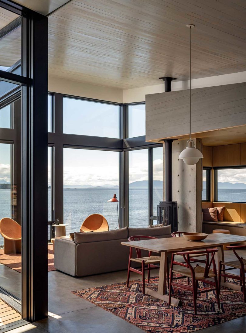 interior view of modern living space with dining room and living room overlooking the water