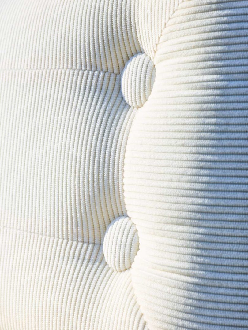 closeup view of tufted white corduroy fabric on chair