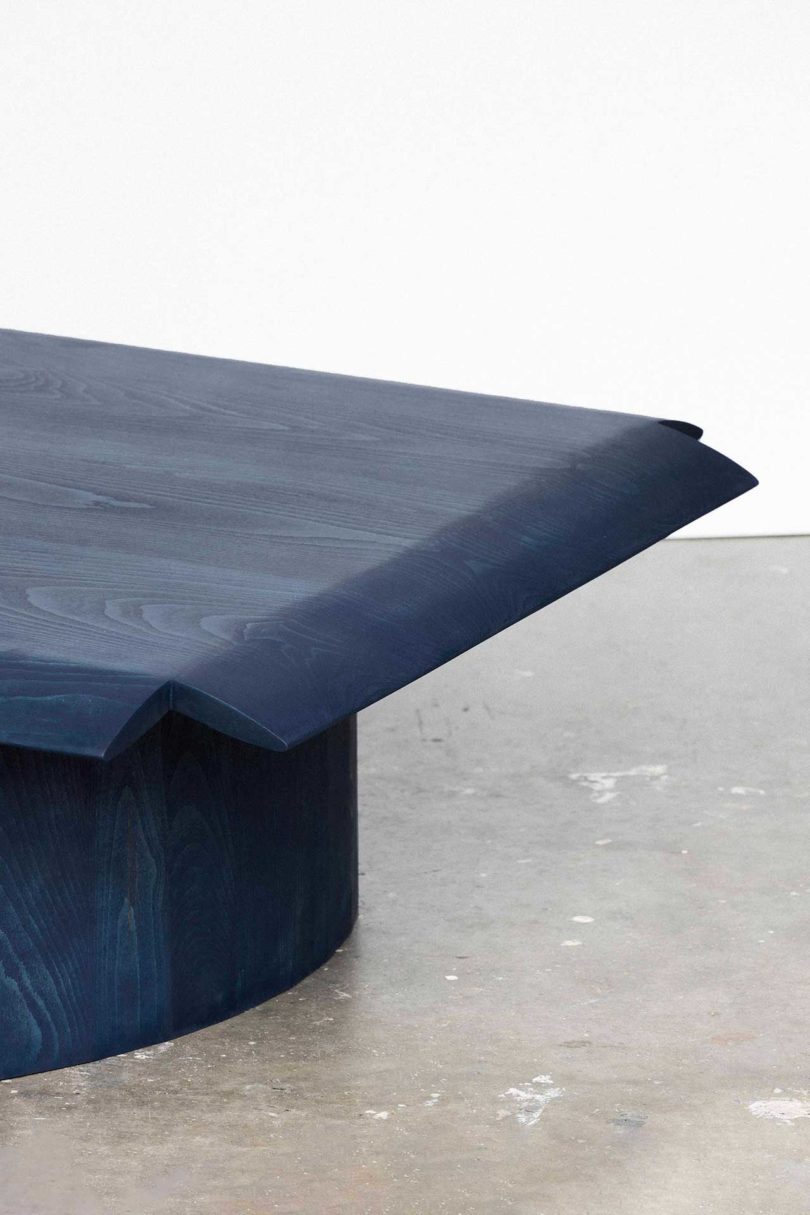 detail of blue coffee table with tipped-down edges