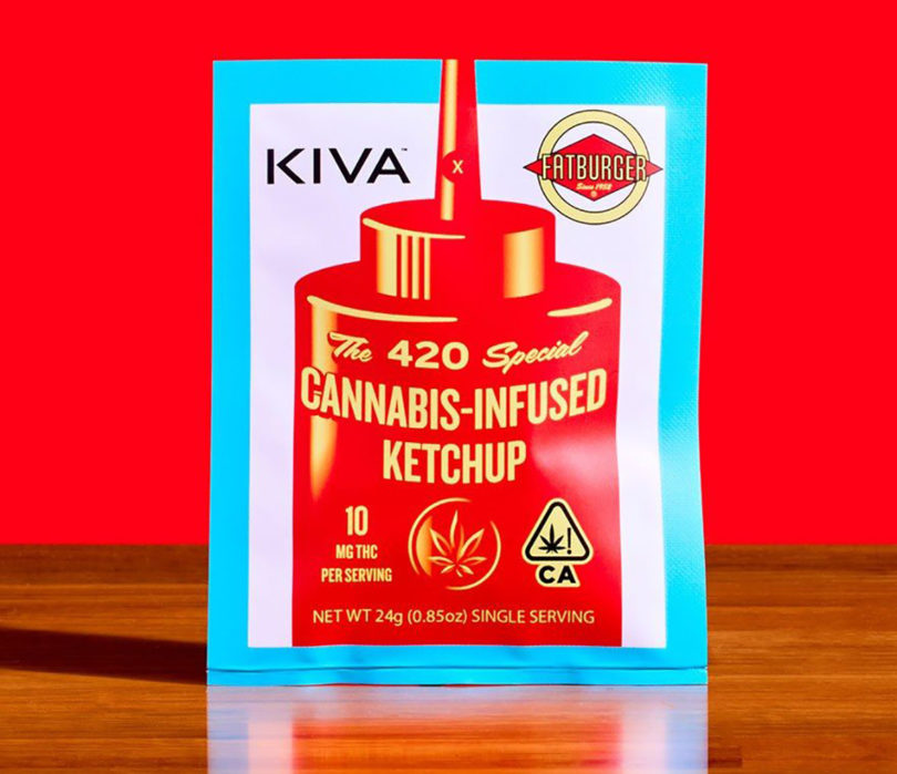 Package of cannabis-infused ketchup against red background set vertically on wood surface