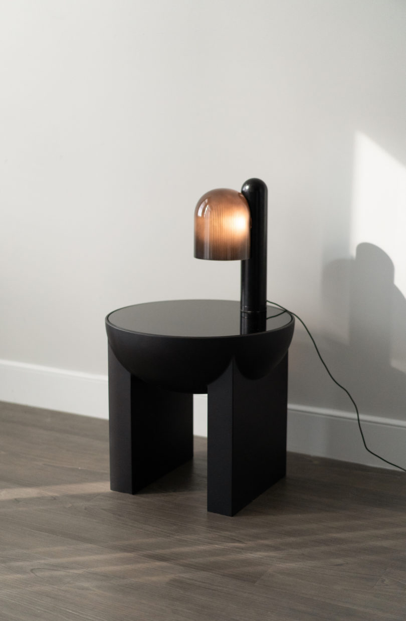 black side table with attached lamp
