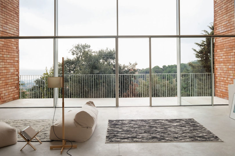 black and ivory rug next to windows