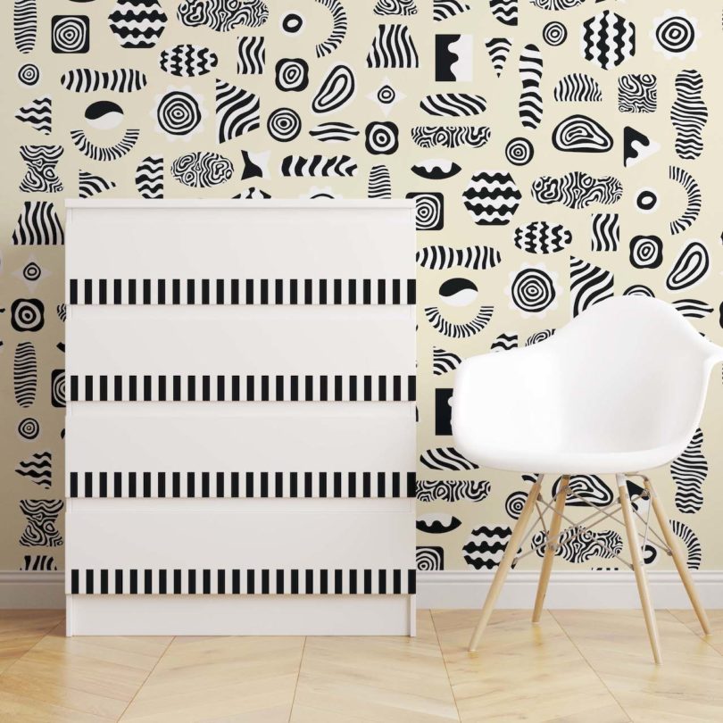 black and white wallpaper next to white chair